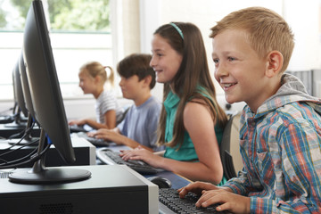 4 students at computers in class